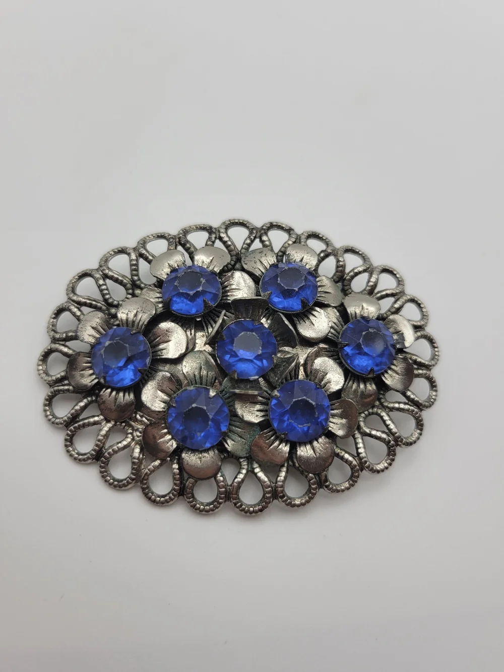 Vintage-Inspired Silver Floral Brooch with Blue Crystal Accents